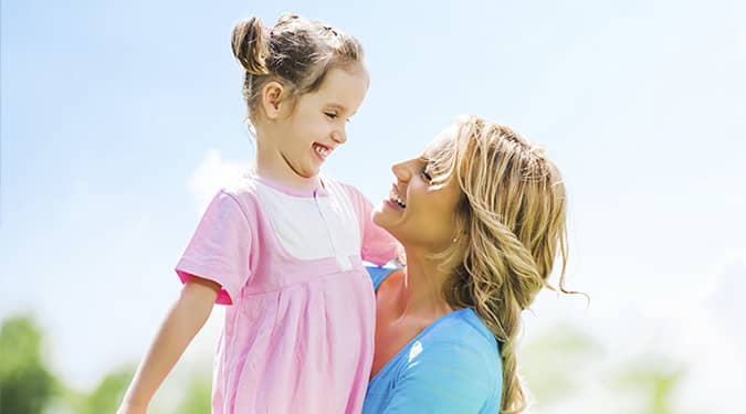 Woman and young girl smiling